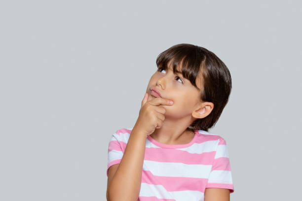 istock Cute little girl looking up, just have an idea, Copy space 1280698369