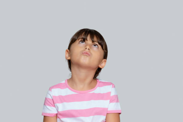 istock Cute little girl looking up, just have an idea, Copy space 1280698384