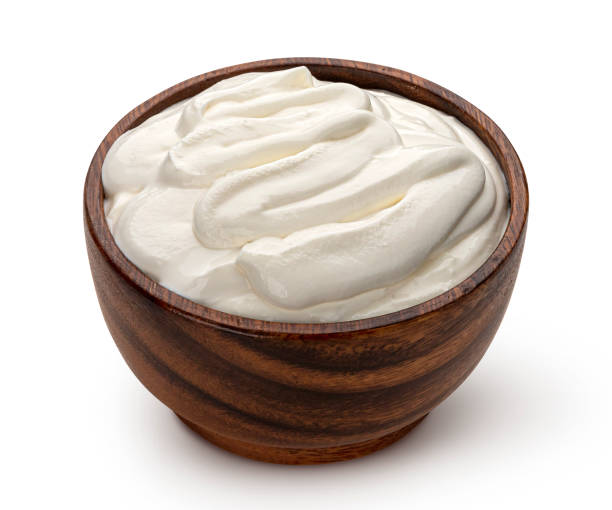 istock Sour cream in wooden bowl isolated on white background 1280703440