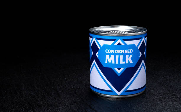 istock Condensed milk can on black background 1280703449