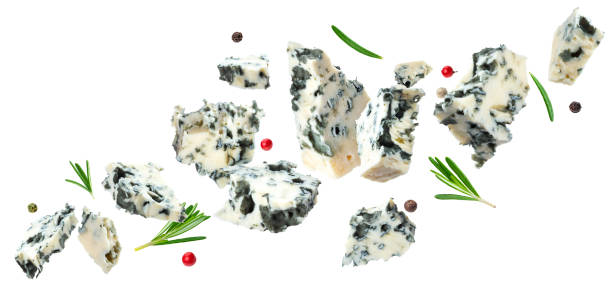 Falling danish blue cheese isolated on white background Falling danish blue cheese isolated on white background with clipping path, flying blue cheese pieces roquefort cheese stock pictures, royalty-free photos & images