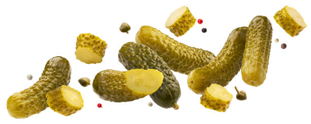 Pickled gherkins, marinated cucumbers isolated on white background