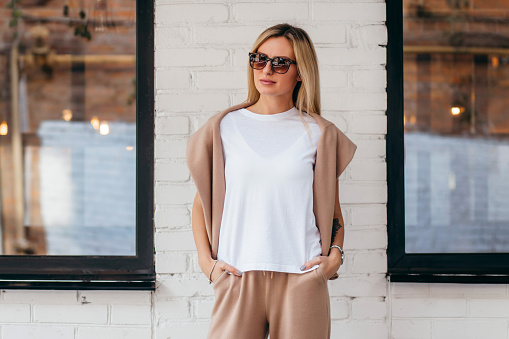 Stylish blonde girl wearing white t-shirt and glasses