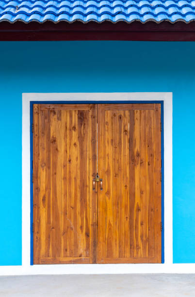 istock Dirty wooden door and blue wall. 1280706095