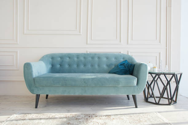 istock Blue sofa and coffee table on white wall background, stylish interior design 1280707624