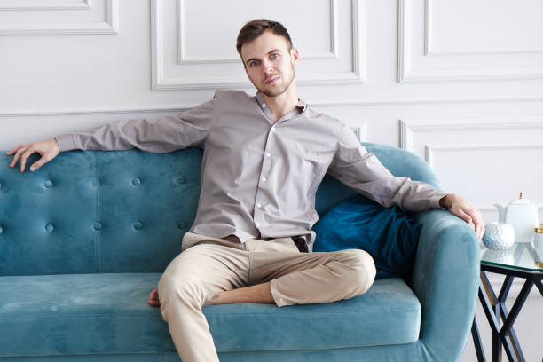 istock Caucasian man sitting relaxing on sofa at home, luxury interior 1280707628