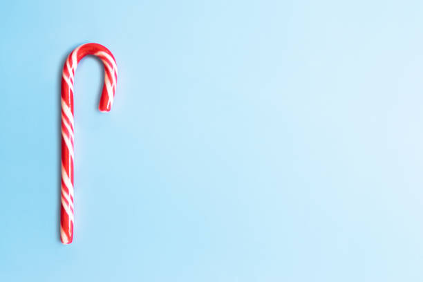 istock Candy cane on a blue background. Christmas sweets. 1280712985
