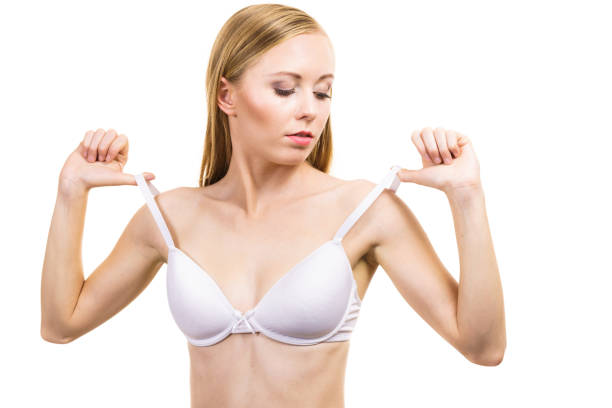 istock Young woman holding bra strap 1280714305