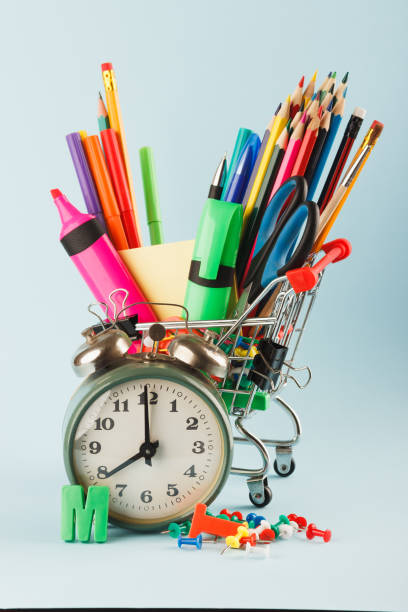 istock Shopping cart with different stationery on the blue background 1280714397