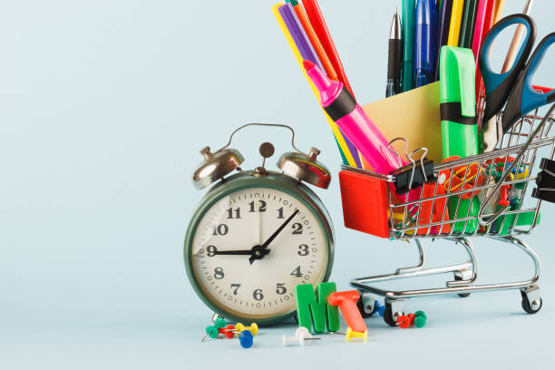 istock Shopping cart with different stationery, light blue background 1280714459