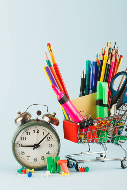 istock Shopping cart with different stationery, light blue background 1280714529