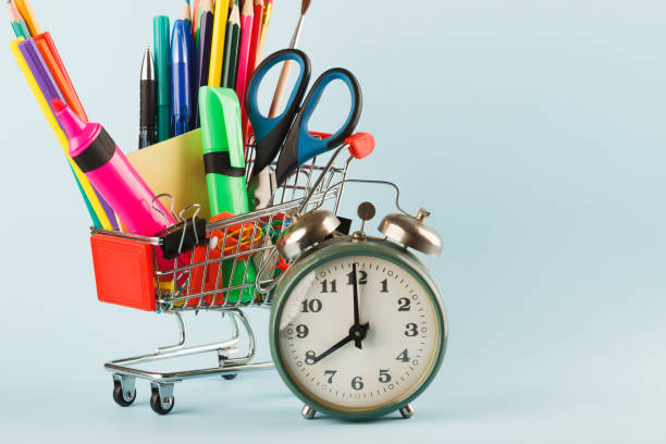 istock Shopping cart with different stationery, light blue background 1280715388