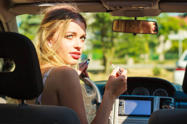 istock Girl apply make up while driving car. 1280716519