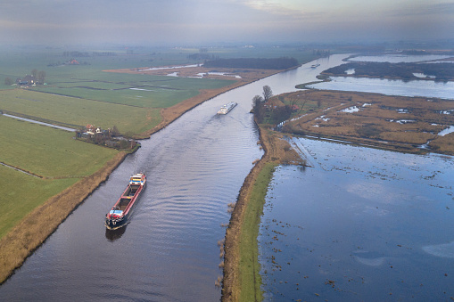 Aerial view of inland freight ships in canal in Friesland. The Netherlands