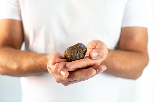 A man carefully holds a Dolomite (Stone) in his hands