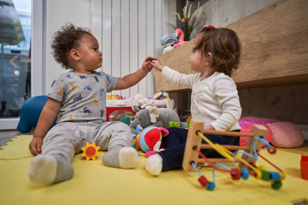 istock Innocent and curious babies exploring themslefs, with a touch so they can acquire social skills 1280720926
