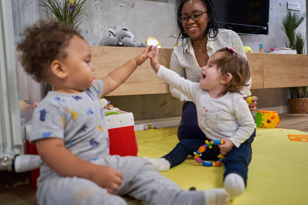 istock Cheerful nanny can't hide her excitment after she succesfuly learnd babies how to exchange a high five 1280721101