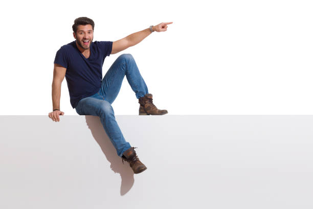 istock Happy Handsome Man Is Sitting On A Top Pointing And Talking 1280722070