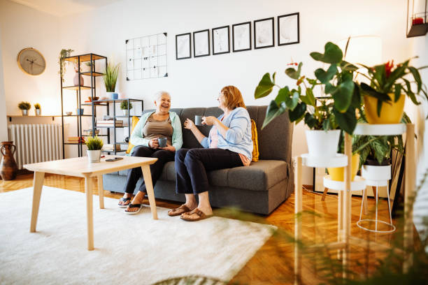 istock Senior women at home, sitting on sofa and drinking coffee or tea 1280725651