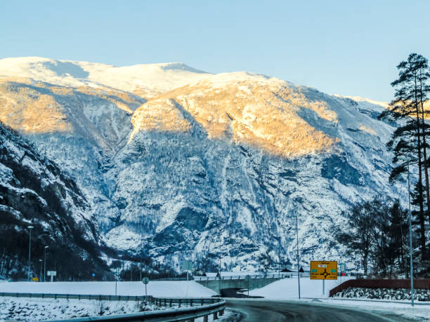 istock Driving at sunrise through mountains and forests in Norway. 1280726962