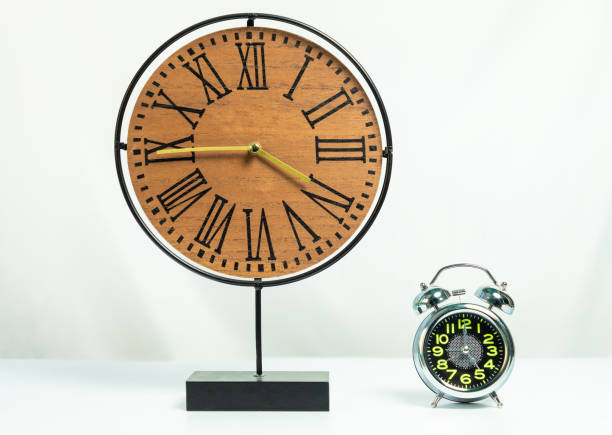 istock Wood clock with shiny alarm clock 1280728169