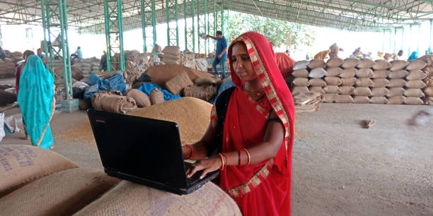 Indian village people using technology equipment District Katni, Madhya Pradesh, India - 25 August 2019: An indian village woman farmer working on laptop computer at agriculture government go down. village maharashtra stock pictures, royalty-free photos & images