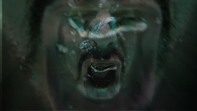 Face of man screaming under water