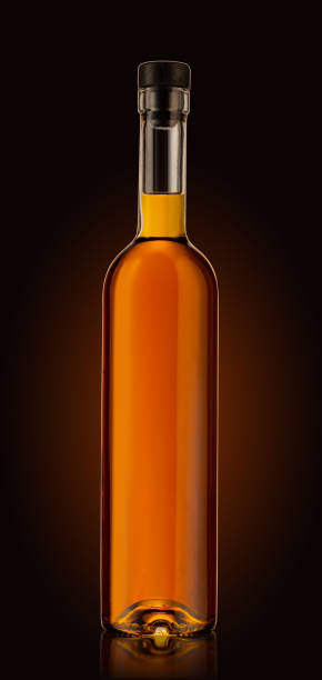 istock Bottle of premium alcohol, isolated on dark background. Ideal for a mock-up design. 1280737005