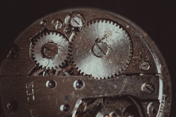 istock Old clockwork mechanism in close-up. Selective focus on macro details. Light vintage toning. Grunge style backdrop 1280738389