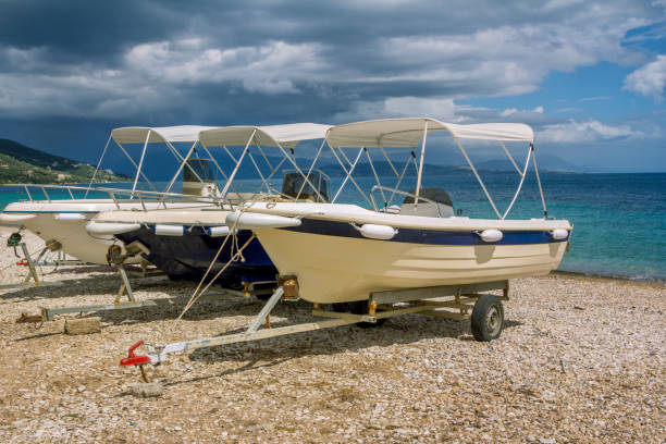 istock White cruise boats on trailers for transportation on the beach 1280739342