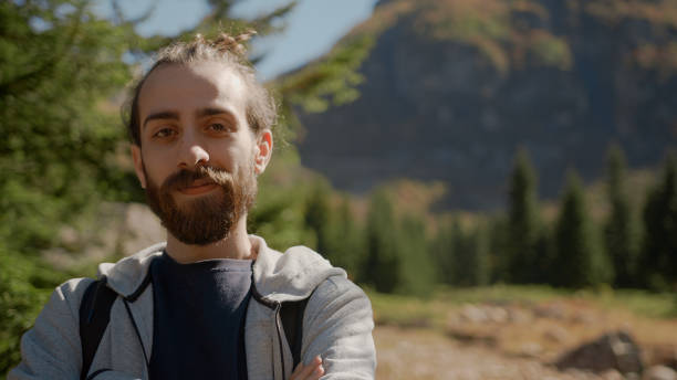 istock Hippie climber looking confident look at camera with arms crossed in nature with backpack, nature lifestyle concept 1280739718