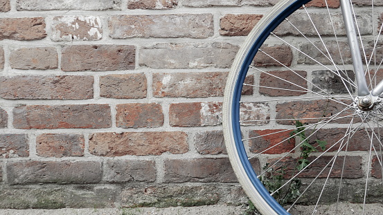 A Dutch bike rests against a red brick wall in The Netherlands.
