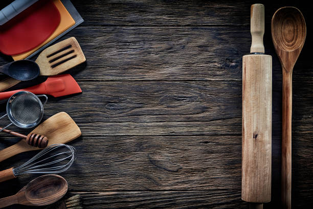 istock Top view of wooden kitchen utensils on rustic table with copy space. 1280744008