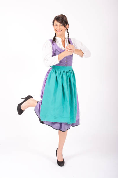 istock young brunette woman wearing a bavarian dirndl and dancing on white background 1280744013