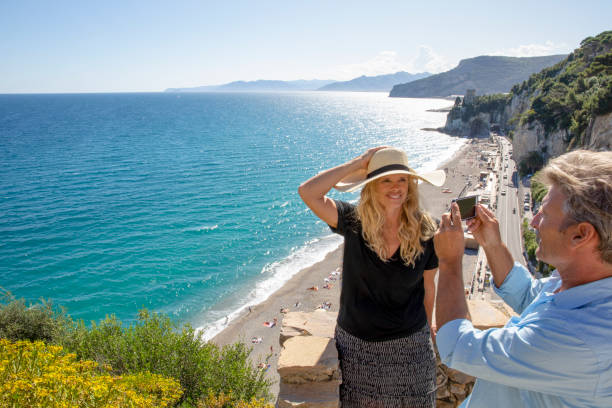 istock Mature couple relax beside elevated coastal wall 1280744208