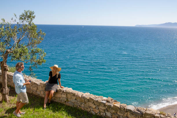 istock Mature couple relax beside elevated coastal wall 1280745048