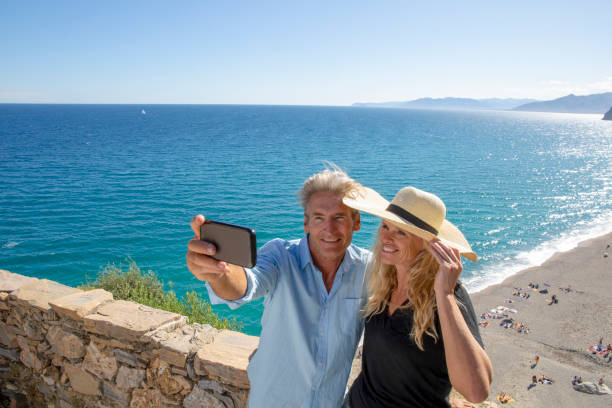 istock Mature couple relax beside elevated coastal wall 1280745354
