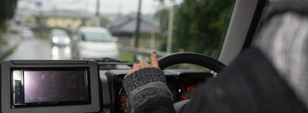 istock Woman driving a car on a rainy day 1280745448