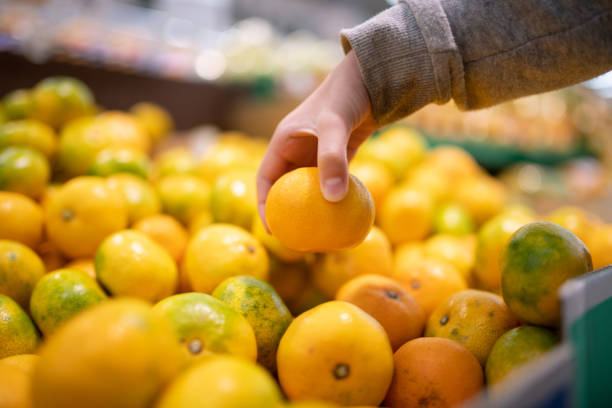 istock Children's hands choosing oranges in the supermarket 1280745508