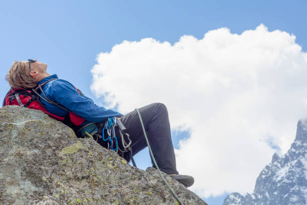 istock Mountaineer relaxes on mountain ridge 1280745606