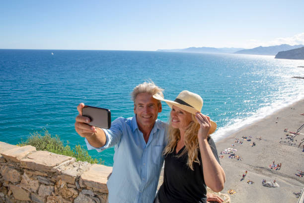 istock Mature couple relax beside elevated coastal wall 1280745668