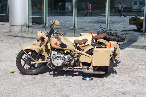 Old motorcycle with chinese red star and sidecar in Essen parked outside of Evonik building