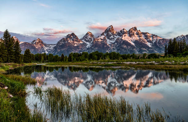 Teton Reflections A long exposure image to capture the reflections of the Grand teton mountain in Grand Teton National Park teton range photos stock pictures, royalty-free photos & images