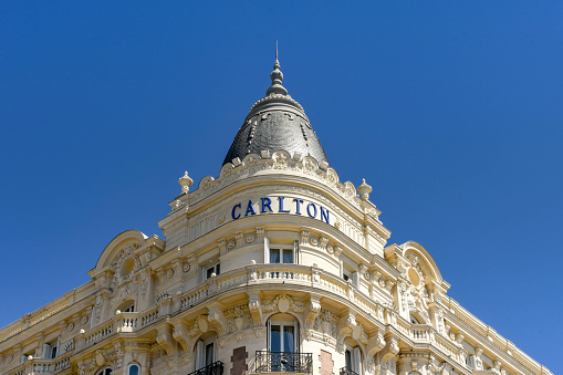 Cannes, France - April 2019:  The corner of the ornate Carlton Hotel, which is a landmark on the seafront in Cannes.