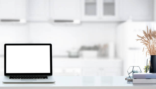 istock Mockup laptop computer with blank screen on white counter table in kitchen room, copy space. 1280750559