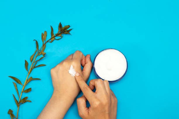 istock closeup woman applying cream on her hands 1280751763