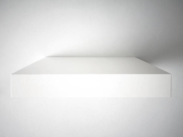 Front view of white wall shelf. Elegant and minimalist design. Empty floating shelf on white wall. Interior decoration background.