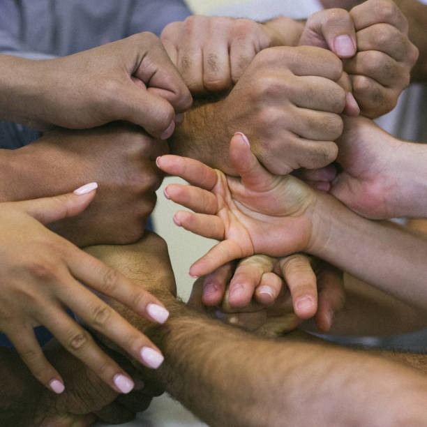 istock people's hands of different races together 1280756463