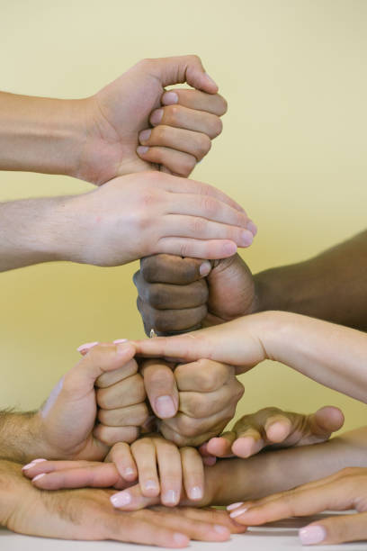 istock people's hands of different races together 1280756470