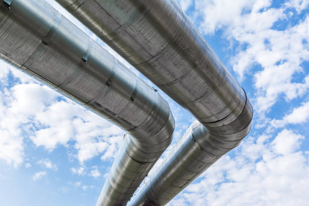 istock heating pipes in isolation against a blue sky with clouds 1280756543